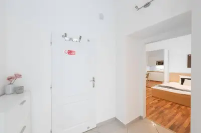 a white room with a bed and a white wall at Adorable Cozy Studio in Central Prague in Prague