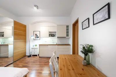 a kitchen and dining room with a table and chairs at Beautiful Cozy Studio Gem near Old Town in Prague