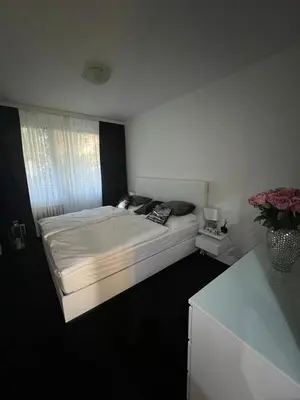 a bedroom with a large bed with a window at Útulný prostorný tichý byt v blízkosti centra in Prague
