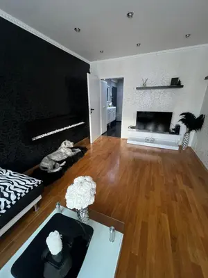 a living room with a couch and a table at Útulný prostorný tichý byt v blízkosti centra in Prague
