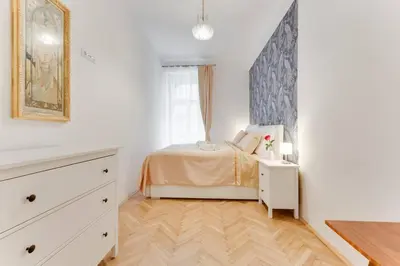 a bedroom with a bed and a dresser and a window at Prague Days - Three-bedroom Apartment with Balcony in Prague