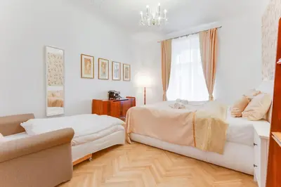 a bedroom with two beds and a window at Prague Days - Three-bedroom Apartment with Balcony in Prague