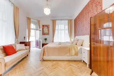 a bedroom with a bed and a couch at Prague Days - Three-bedroom Apartment with Balcony in Prague