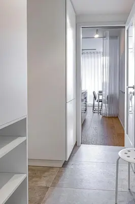 a room with white walls and a dining room at Prague Days - Studio Apartment with Garage Parking and Balcony in Prague