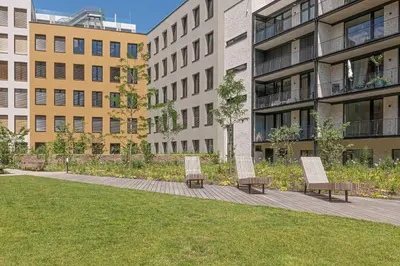 two chairs on a sidewalk in front of buildings at Prague Days - Studio Apartment with Garage Parking and Balcony in Prague