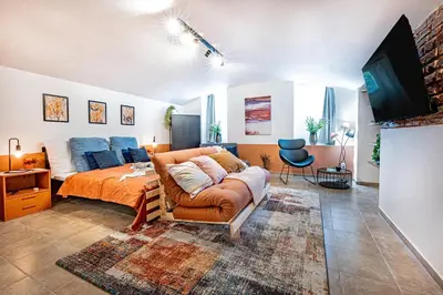 a bedroom with a bed and a couch at Prague Days - Studio with Netflix at Náměstí Míru in Prague