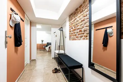 a hallway with a walk in closet and a brick wall at Prague Days - Studio with Netflix at Náměstí Míru in Prague