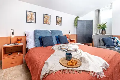 a bedroom with a bed with a tray of food on it at Prague Days - Studio with Netflix at Náměstí Míru in Prague