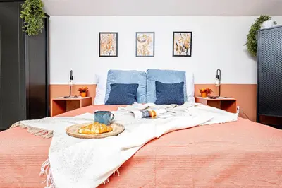 a bed with a blanket and a bowl of fruit on it at Prague Days - Studio with Netflix at Náměstí Míru in Prague