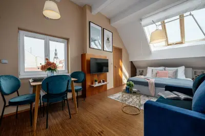 a bedroom with a bed and a couch and a table at Prague Days - Studio in a prime location with AC close to the Charles Bridge in Prague