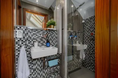 a bathroom with a sink and a shower at Prague Days - Studio in a prime location with AC close to the Charles Bridge in Prague