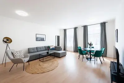 a living room with a couch and a table and chairs at Spacious Luxury Old Town 2BR Retreat in Prague