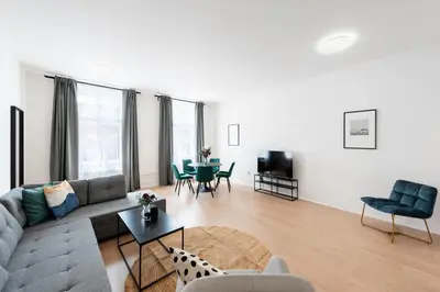 a living room with a couch and a table at Spacious Luxury Old Town 2BR Retreat in Prague