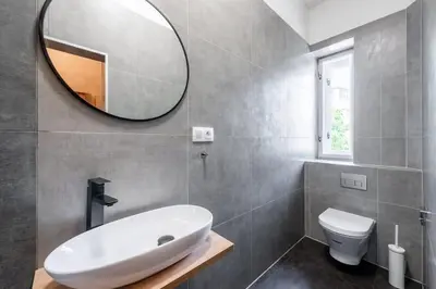 a bathroom with a white sink and a mirror at Spacious Luxury Old Town 2BR Retreat in Prague