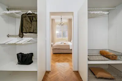 a room with white shelves and a bedroom with a bed at Prague Days - One-bedroom Apartment with Workspace in the Old Town in Prague
