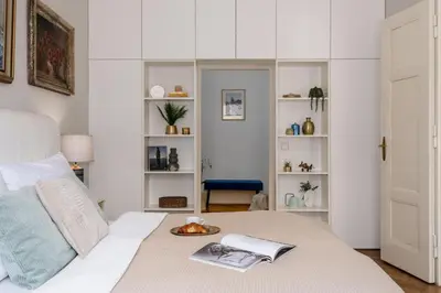 a bedroom with a bed with a book at Prague Days - One-bedroom Apartment with Workspace in the Old Town in Prague