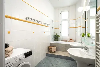 a white bathroom with a sink and a toilet at Prague Days - One-bedroom Apartment with Workspace in the Old Town in Prague