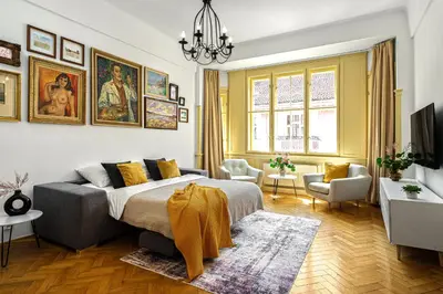 a bedroom with a bed and a living room at Prague Days - One-bedroom Apartment with Workspace in the Old Town in Prague