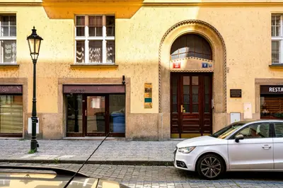 a white car parked in front of a building at Prague Days - One-bedroom Apartment with Workspace in the Old Town in Prague