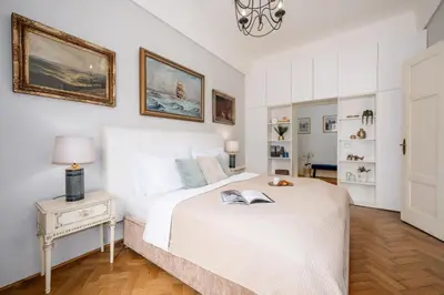 a bedroom with a bed and a table with a book on it at Prague Days - One-bedroom Apartment with Workspace in the Old Town in Prague