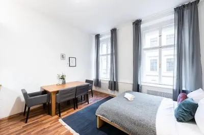 a bedroom with a table and a bed and a desk at Modern Loft Getaway in Prague