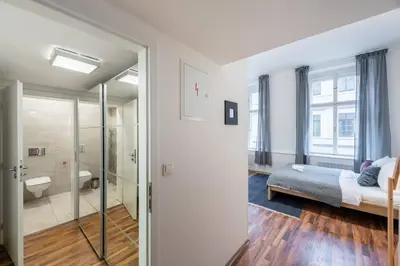 a bedroom with a bed and a bathroom with a shower at Modern Loft Getaway in Prague