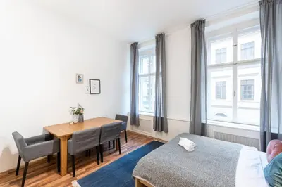 a bedroom with a table and a bed and a window at Modern Loft Getaway in Prague