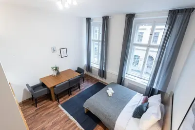 a living room with a bed and a table at Modern Loft Getaway in Prague