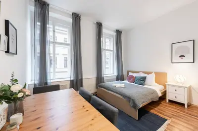a bedroom with a bed and a wooden table at Modern Loft Getaway in Prague