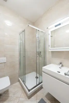 a bathroom with a shower and a toilet and a sink at Timeless Charming Studio near Old Town in Prague