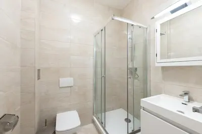 a bathroom with a shower and a toilet and a sink at Timeless Charming Studio near Old Town in Prague