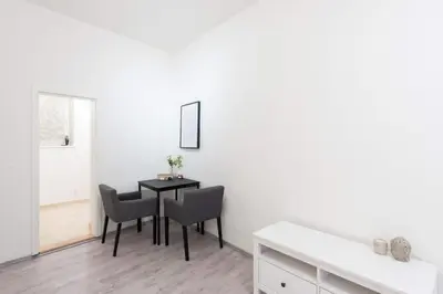 a dining room with a black table and chairs at Timeless Charming Studio near Old Town in Prague