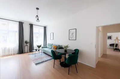 a living room with a couch and a table at Unique Old Town 2BR Oasis with Sofa Bed in Prague