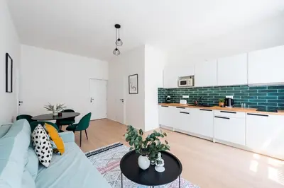 a living room with a couch and a table at Unique Old Town 2BR Oasis with Sofa Bed in Prague