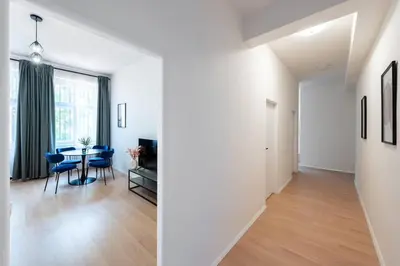 a white apartment with a dining room and a living room at Urban 2BR Haven with Sofa Bed in Central Prague in Prague