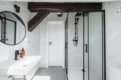 a bathroom with a shower and a sink and a mirror at Wonderful Romantic Old Town Apt in Prague