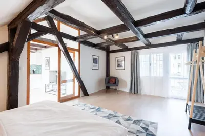 a bedroom with a bed and a large window at Wonderful Romantic Old Town Apt in Prague