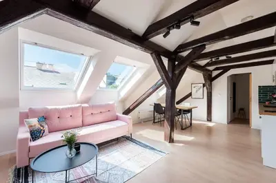 a living room with a pink couch and a table at Wonderful Romantic Old Town Apt in Prague