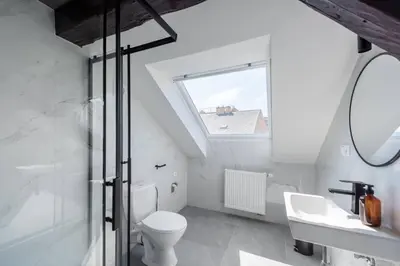 a bathroom with a toilet and a sink and a window at Wonderful Romantic Old Town Apt in Prague
