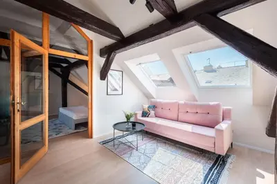 a living room with a pink couch and a table at Wonderful Romantic Old Town Apt in Prague