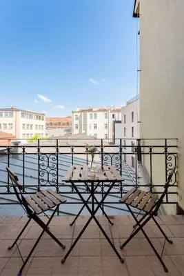 a table and chairs on top of a balcony at Wonderful Romantic Old Town Apt in Prague