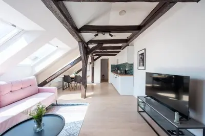 a living room with a pink couch and a table at Wonderful Romantic Old Town Apt in Prague
