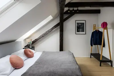 a bedroom with a bed with pillows on it at Zesty Family Friendly Elevator Access Old Town in Prague
