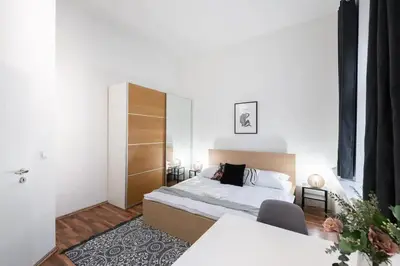 a bedroom with a large bed and a table at Friendly Studio for Two Old Town in Prague
