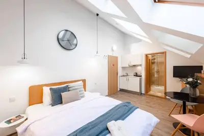 a bedroom with a bed and a desk and a tv at Delightful Old Town Studio in Prague