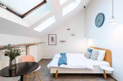 a bedroom with a bed and a table at Delightful Old Town Studio in Prague