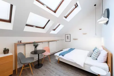 a bedroom with a bed and a table and chairs at Delightful Old Town Studio in Prague