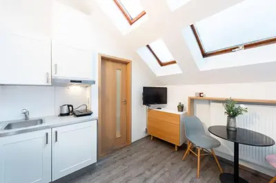 a kitchen with a sink and a table at Delightful Old Town Studio in Prague