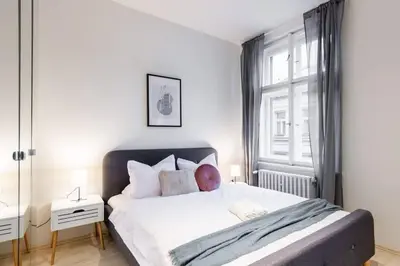 a bedroom with a large bed and a window at Welcoming Studio in Historic Prague in Prague