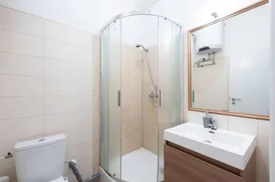 a bathroom with a shower and a sink and a toilet at Welcoming Studio in Historic Prague in Prague